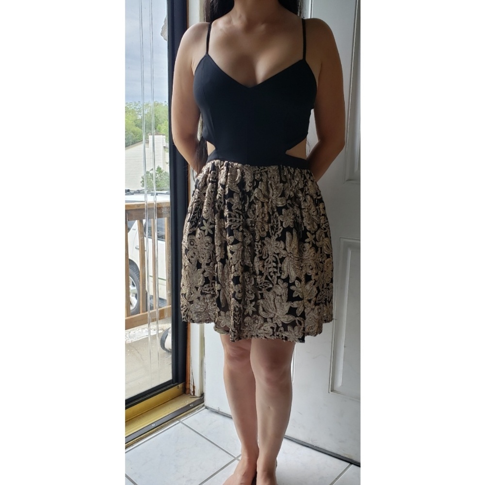 Black and gold sequined dress with cutouts